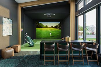 a golf simulator in a room with a table and chairs